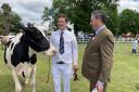 John Smith with his supreme inter-breed dairy champion cow and judge Barry Daw