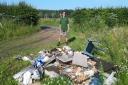Norfolk farmer Andy Wortley with rubbish illegally fly-tipped on his land at Methwold