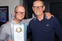 Dean Gould with his Record Holders Republic special achievement award to mark 40 years of record breaking and councillor Seamus Bennett, who presented the award on behalf of the US RHR.