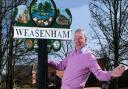 The 'Weasenham whinger' received criticism after posing with the village sign
