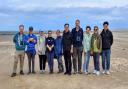Visitors from the Republic of Korea, with RSPB staff on the beach at Titchwell