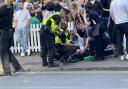 Police treating a man who was knocked out during the England vs Denmark game at The Woolpack