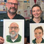 Apprentice paramedic Ian Betts and newly qualified paramedic Toula Skylogiannis receive painted portraits