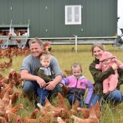 West Norfolk farmer David Cross with his wife Mari and their children Osian, two, Elsi, five, and five-month-old Nel, outside one of their new mobile hen houses at Sedgeford