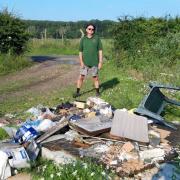 Norfolk farmer Andy Wortley with rubbish illegally fly-tipped on his land at Methwold