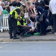 Police treating a man who was knocked out during the England vs Denmark game at The Woolpack