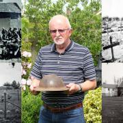 Dennis O'Callaghan, son of one of the two who survived the massacre, holds the helmet recovered from a French barn, with a picture of the surrender, the soldiers' graves and the farm where the atrocity took place