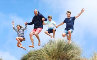 The image, released alongside a message wishing The Prince of Wales a happy 42nd birthday, shows the future king jumping alongside his three children