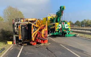 The A11 will remain closed overnight after a lorry overturned and spilt oil on the road