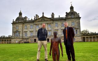 Sir Antony Gormley (left) and Lord Cholmondeley with one of the statues at Houghton Hall