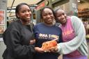 Tola Durowoju has opened Buka Street in Norwich Market. Pictured: Tola, centre, and her daughters, Zarah, left, and Amanah