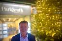 David Stern, director of Parkheath estate agents, in front of their Christmas tree in Haverstock Hill, Belsize Park