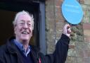 Sir Michael Caine in 2003 with his blue plaque in North Runcton