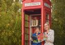 The phone box at Swanton Morley village hall has been converted into a book exchange. Pictured are Faye le Bon and her son George (10). Picture: Ian Burt