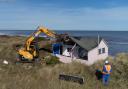 One of the cliff-top homes at Hemsby being demolished