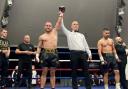 Ryan Walsh's arm is raised in victory by referee  Sean McAvoy