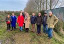 Liz Truss (centre) with villagers at the proposed West Dereham travellers' site