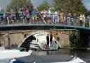 Crowds gathered to watch after a boat became stuck under Wroxham Bridge