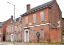 The old schoolhouse sits boarded up and empty in Swaffham town centre