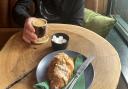 Lloyd Massey enjoying his coffee and almond croissant inside the River Green Pantry, Thorpe St Andrew.