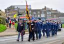 Simon Matthews (front. left) and standard bearer Ralph Hamlet lead the Remembrance Sunday parade to the war memorial at Hunstanton