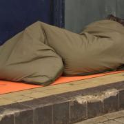 A homeless person sleeping in a doorway. Photo: Getty Images