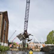 A wrecked boat is recovered from the River Wensum. Picture: Broads Authority