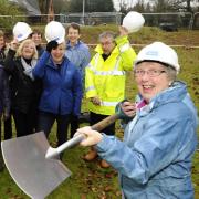 Pat Pinnington cutting the first turf for the new Girlguiding Norfolk archive centre in Coltishall in 2018