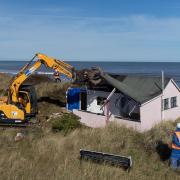 One of the cliff-top homes at Hemsby being demolished