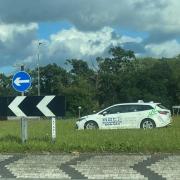 An ABC-branded taxi ended up in the middle of an A11 roundabout