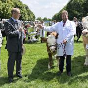 The Duke of Edinburgh presented the trophy for the Royal Norfolk Show's supreme interbreed beef champion to Kenninghall cattle farmers Marcus and Helen Searle