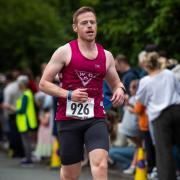 Mark Armstrong runs down the home straight at the Wroxham 5K on Wednesday night