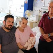 Kyle Hurst, Charley Almey and baby Esme with hospital volunteer David Beveridge (l-r)