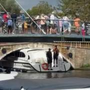 Crowds gathered to watch after a boat became stuck under Wroxham Bridge