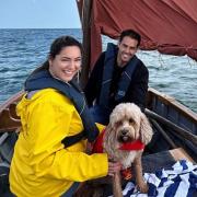 Couple Kelly Brook and Jeremy Parisi with dog Teddy on their Norfolk boat trip