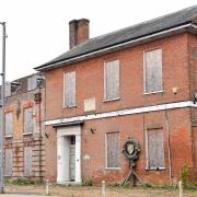 The old schoolhouse sits boarded up and empty in Swaffham town centre