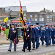 Simon Matthews (front. left) and standard bearer Ralph Hamlet lead the Remembrance Sunday parade to the war memorial at Hunstanton