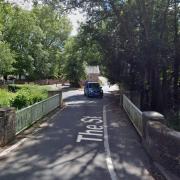 A road was closed for five hours after a car crashed into a bridge