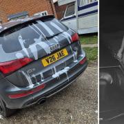 A masked man has vandalised a car in Holt